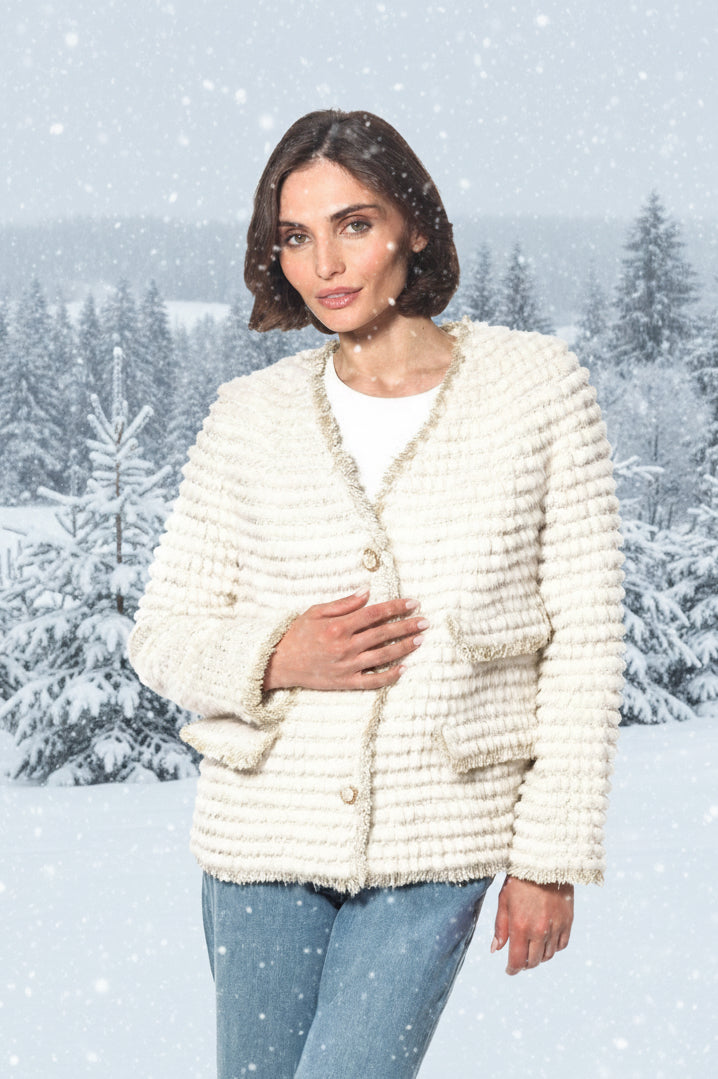 Woman wearing a cream-colored textured jacket on a white background