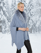 Woman wearing a light blue poncho with a fur collar