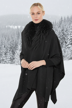 Woman wearing a black poncho with a fur collar