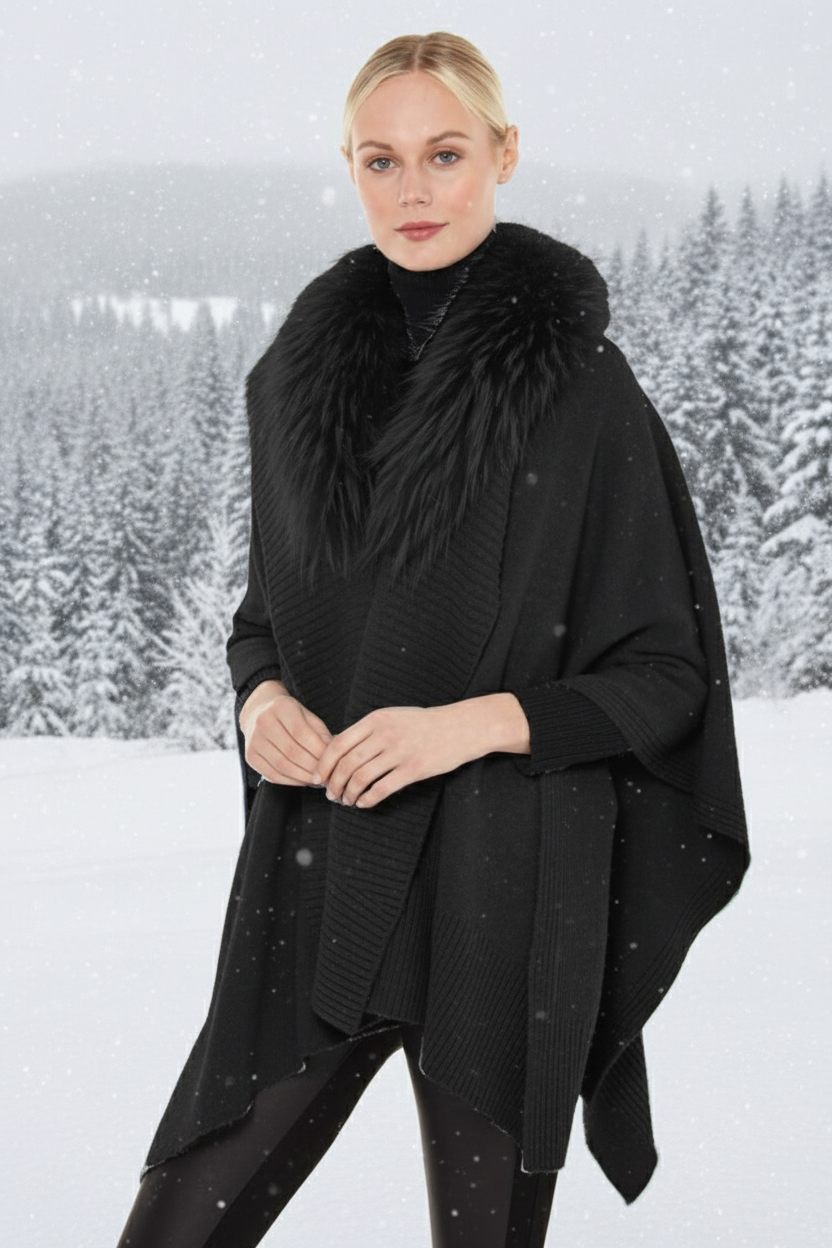 Woman wearing a black poncho with a fur collar
