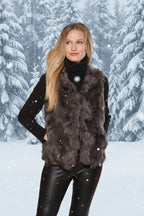Woman wearing a dark fur vest over a black outfit