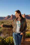 Woman wearing a brown fringe leather jacket on a white background