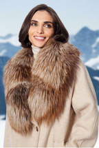 A woman wearing a beige coat with a brown genuine fur collar attached to it.