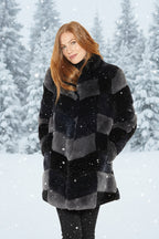 Woman wearing a black and gray checkered fur coat on a white background